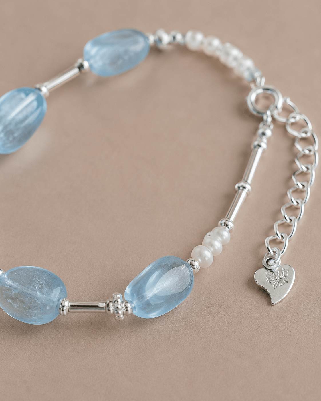 Close-up of aquamarine, pearl and sterling silver details by LUNARAE