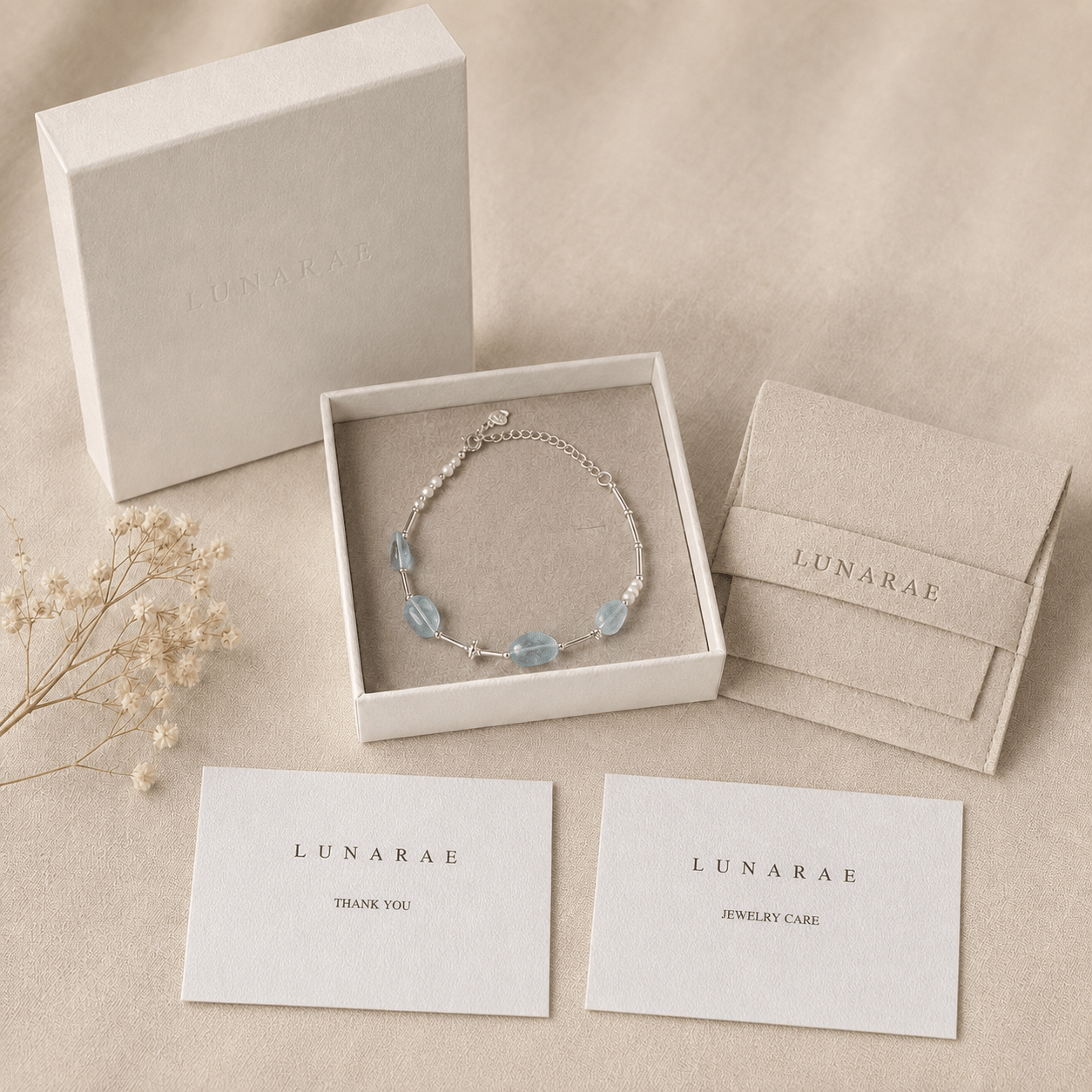 Aquamarine and Pearl Bracelet presented in a LUNARAE jewelry box with a pouch, thank you card, jewelry care card, and dried floral detail