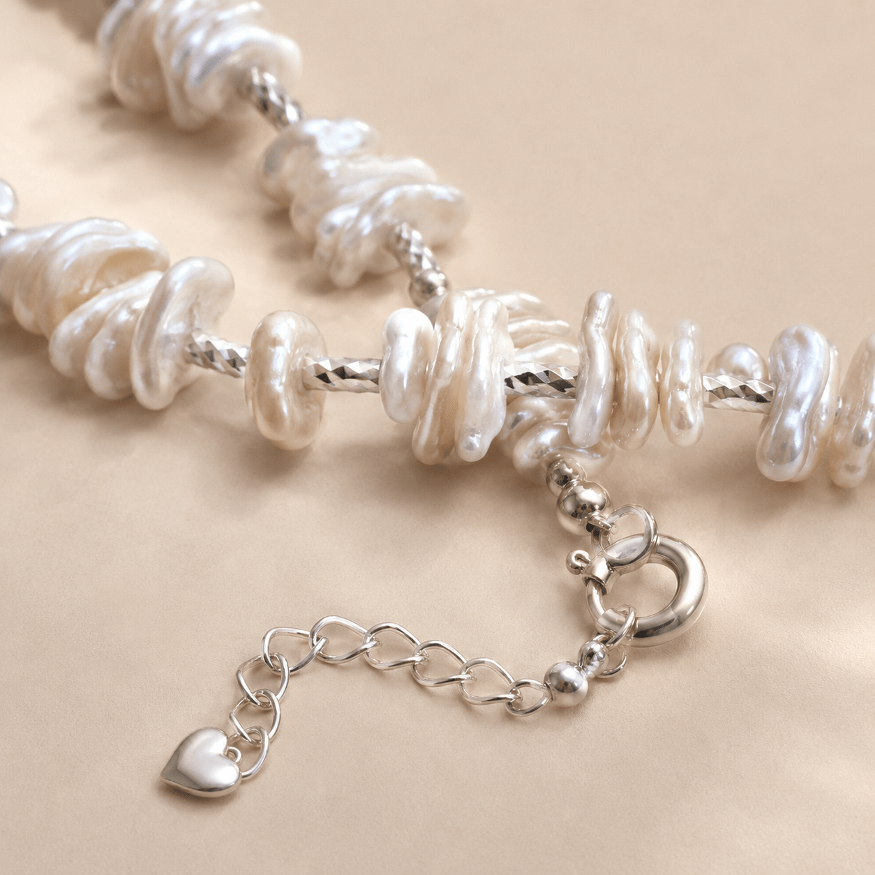 Close-up of the Baroque Pearl Necklace showing irregular pearl shapes, natural luster, and the textured silver-toned chain