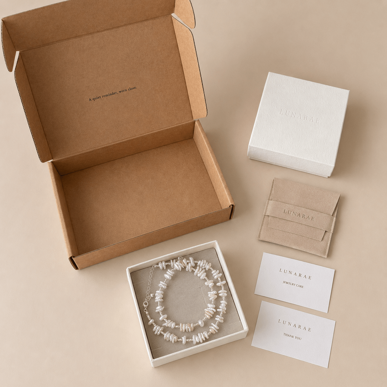Baroque Pearl Necklace presented with LUNARAE packaging including an open mailer box, jewelry box, pouch, thank you card, and jewelry care card