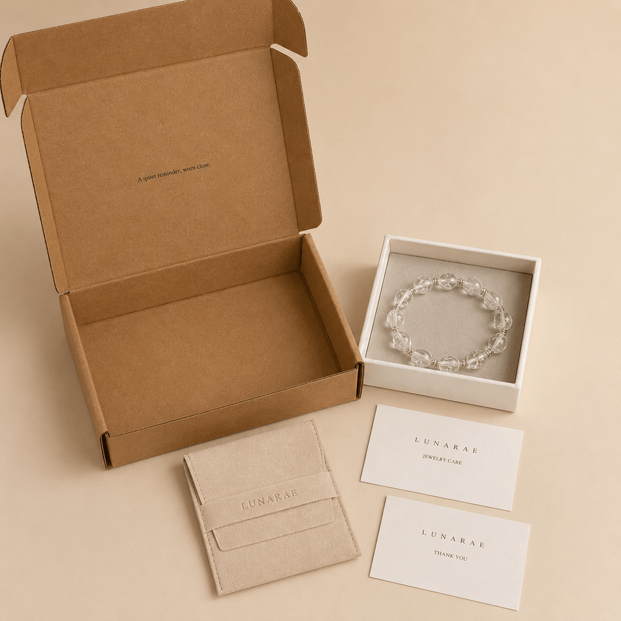 Clear Quartz Silver Bead Bracelet presented with a LUNARAE jewelry box, pouch, jewelry care card, thank you card, and outer mailer box