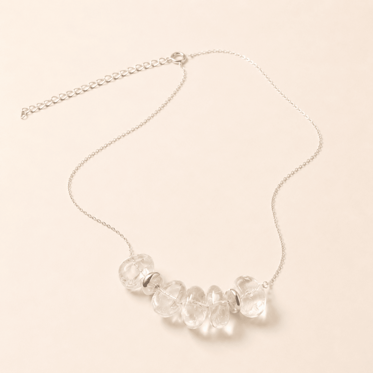 Clear Quartz Pendant Necklace shown from an alternate flat-lay angle with the extender chain visible