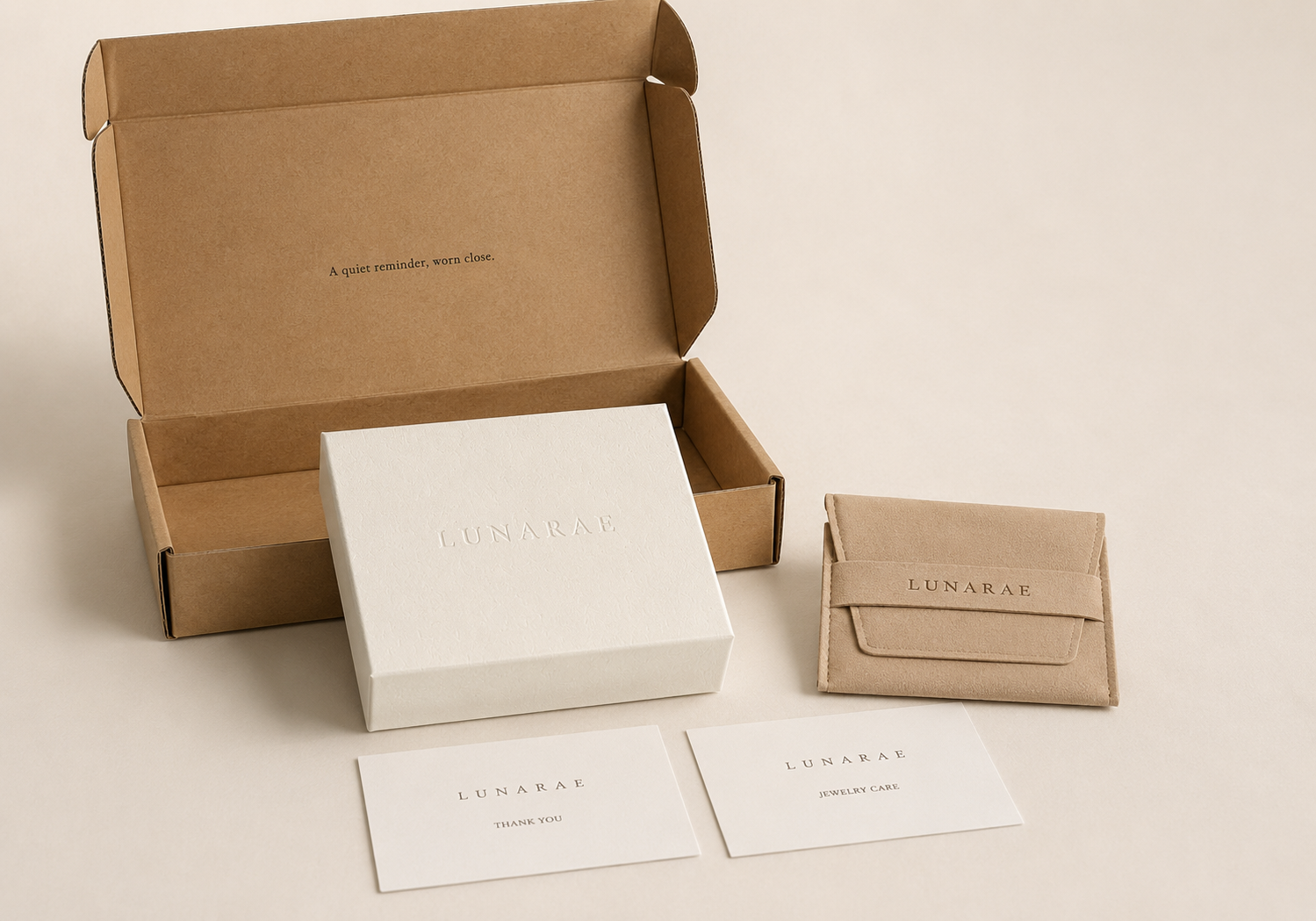 LUNARAE gift-ready jewelry packaging with kraft mailer box, embossed jewelry box, soft jewelry pouch, thank you card, and jewelry care card.