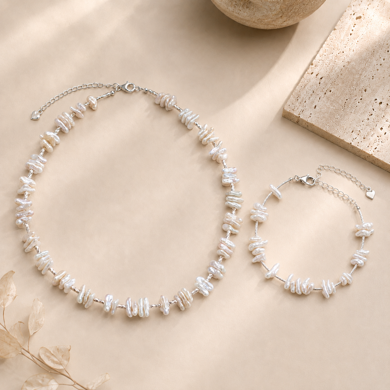 Baroque pearl necklace and matching bracelet styled with ivory satin and warm beige stone for the LUNARAE Grace collection.