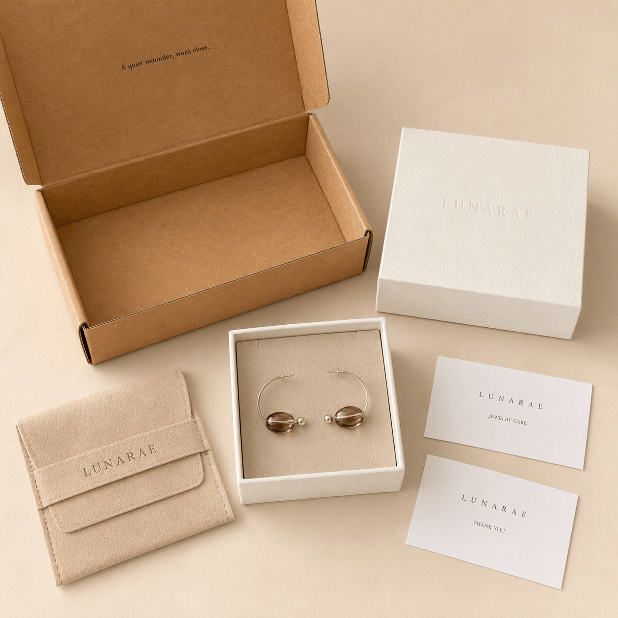 Smoky Quartz Hoop Earrings presented in a LUNARAE jewelry box with outer mailer, pouch, jewelry care card, and thank you card