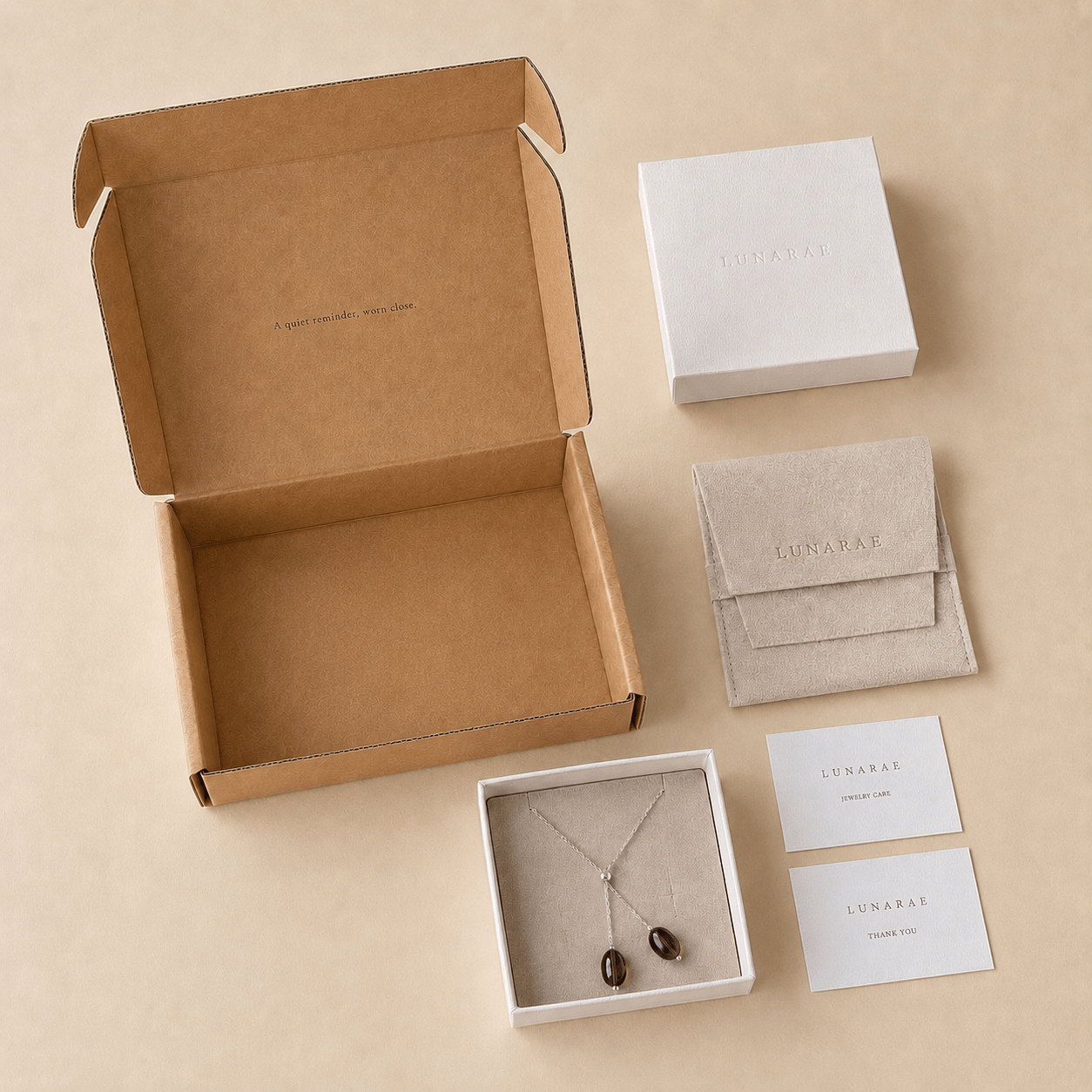 Smoky Quartz Y Necklace presented with LUNARAE packaging including an open mailer box, jewelry box, pouch, thank you card, and jewelry care card