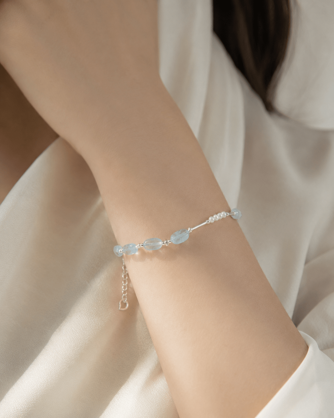 Model wearing Aquamarine and Pearl Silver Bracelet by LUNARAE