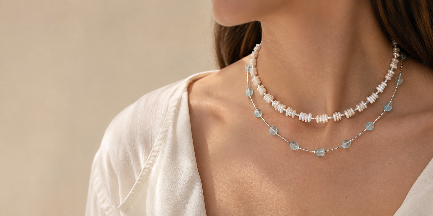 Baroque pearl and aquamarine necklaces layered together in a soft everyday jewelry look by LUNARAE.