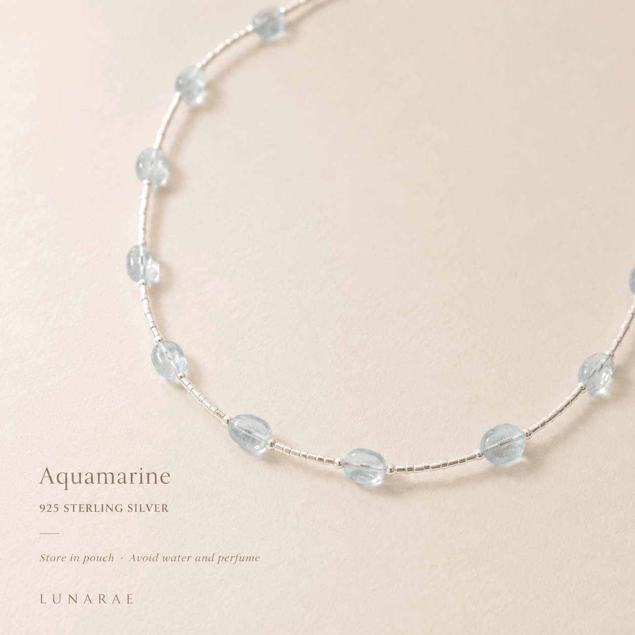 Close-up of the Aquamarine Tube Necklace with text highlighting aquamarine, 925 sterling silver, and storage and care guidance