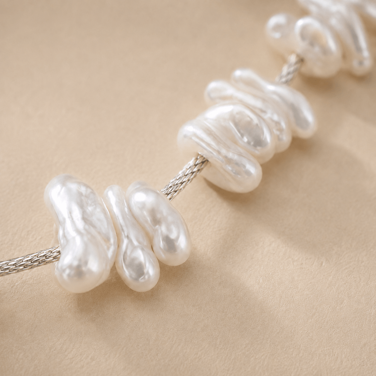 Close-up of the Baroque Pearl Bracelet showing the natural baroque pearl shapes and the sterling silver braided chain