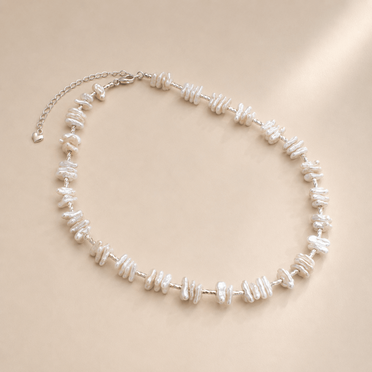 Baroque Pearl Necklace shown from an alternate flat-lay angle with the extender chain and heart-shaped end tag visible