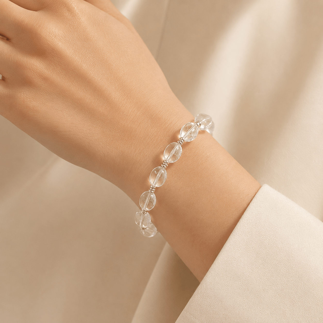 Clear Quartz Silver Bead Bracelet worn on the wrist, showing polished clear quartz beads and sterling silver spacer details