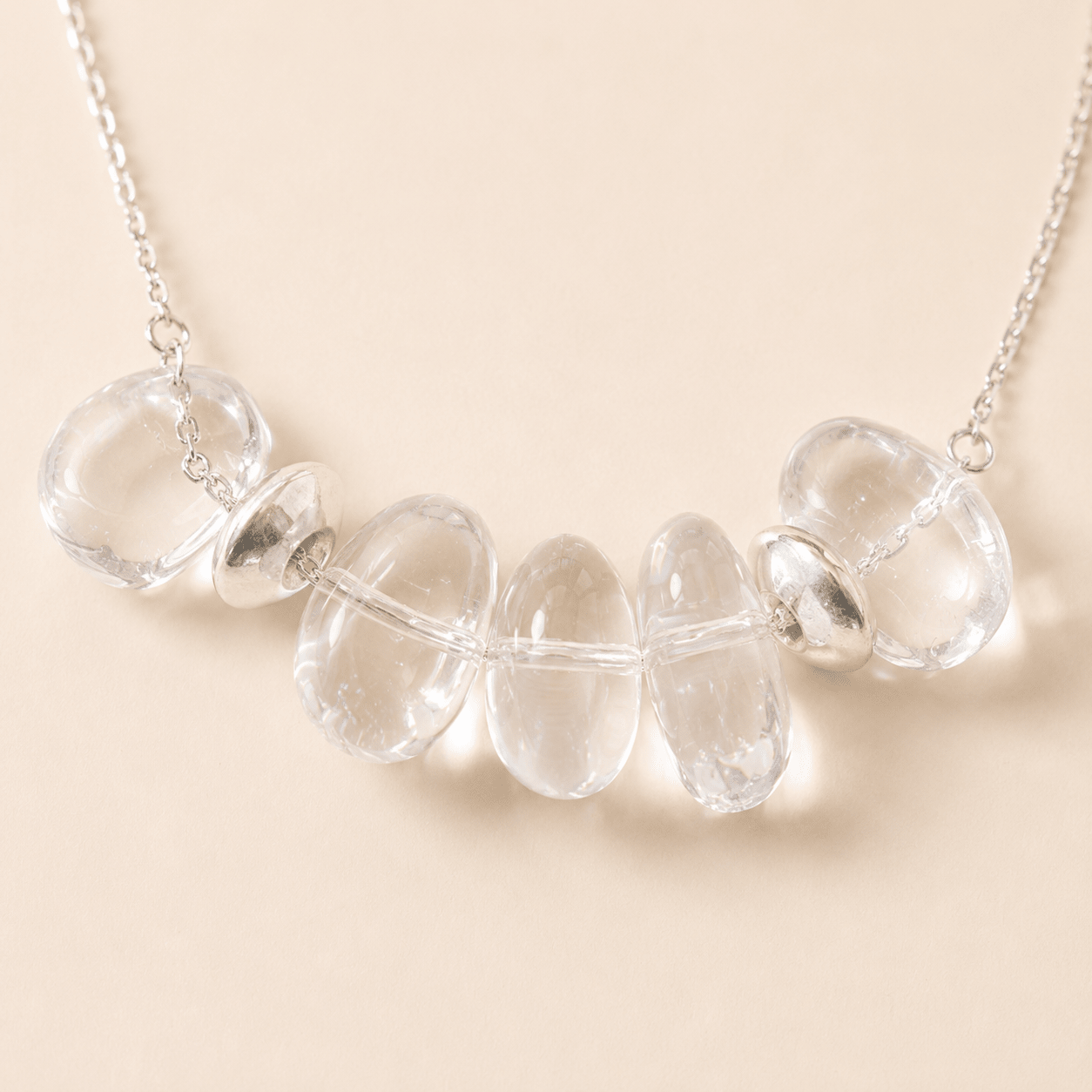 Close-up of the Clear Quartz Pendant Necklace showing five irregular clear quartz stones and sterling silver spacer details