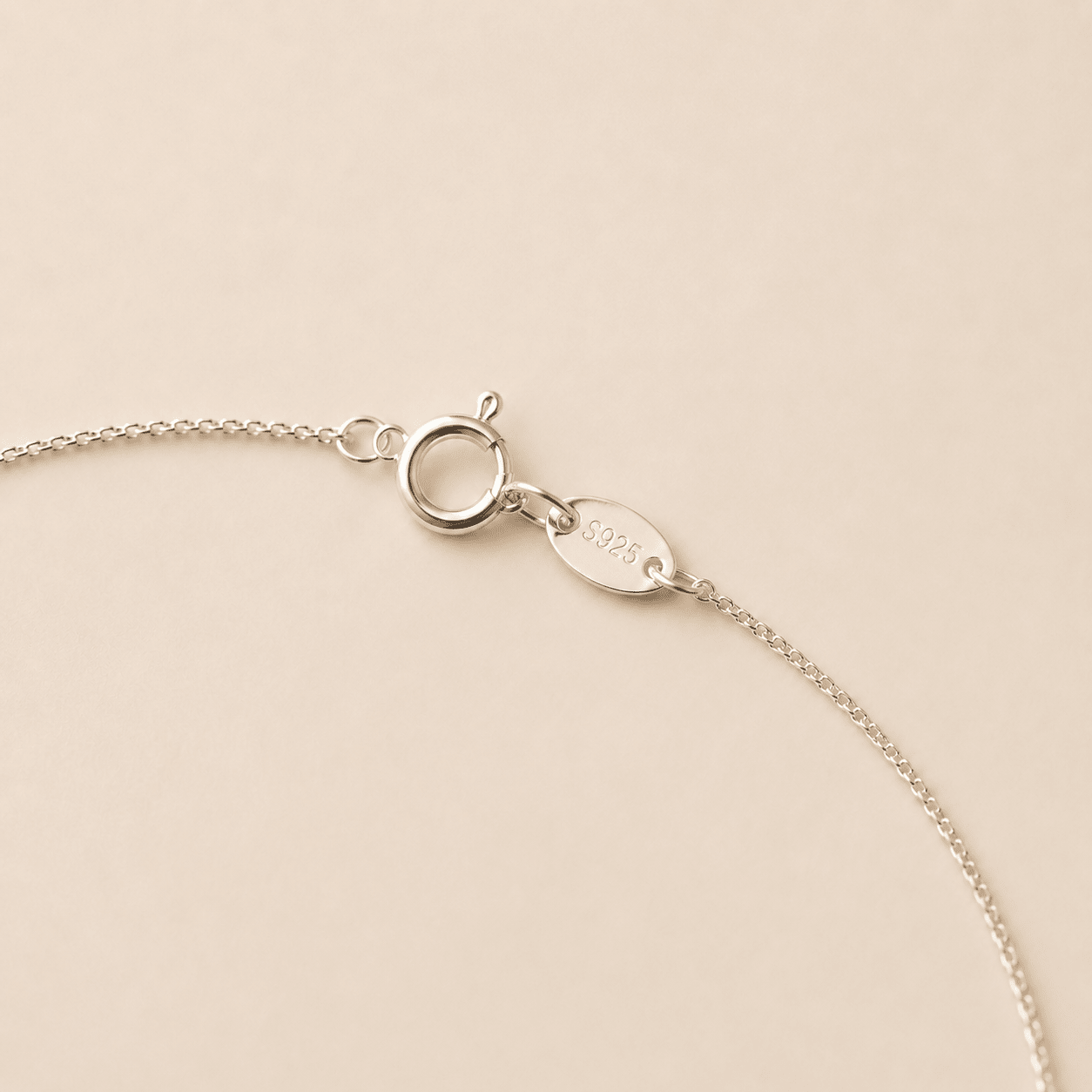 Close-up of the Smoky Quartz Y Necklace spring-ring clasp and S925 silver tag
