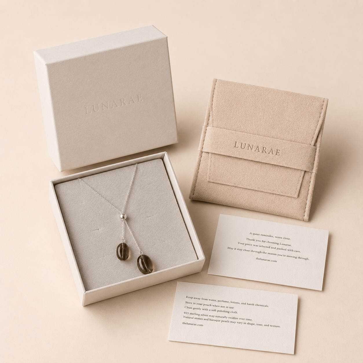Smoky Quartz Y Necklace displayed in a LUNARAE jewelry box with a pouch, thank you card, and detailed jewelry care card